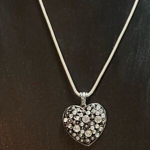 Silver tone heart pendant with light gray, dark gray, and clear rhinestones.